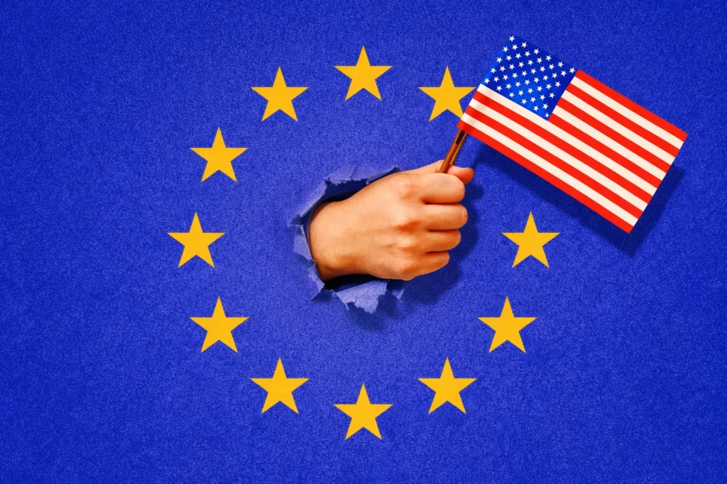 ამერიკის დროშით ხელში გამოსახული ხელი ევროკავშირის დროშის ფონზე — აშშ-ევროპის პოლიტიკური ურთიერთობების სიმბოლური ილუსტრაცია